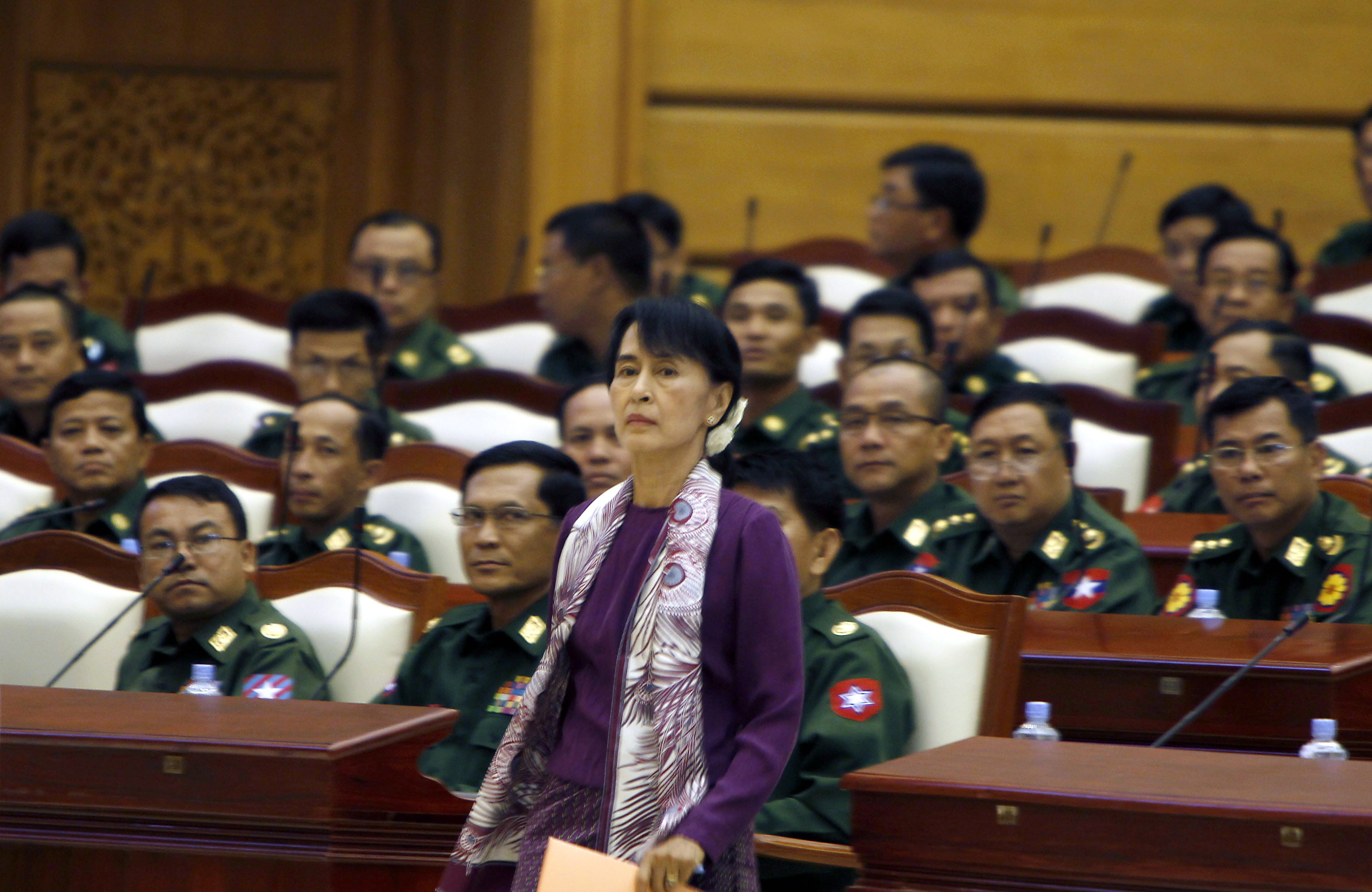 Aung San Suu Kyi stands in front of military representatives on the day she was sworn into parliament, May 2, 2012 (Photo: EPA/NYEIN CHAN NAING)